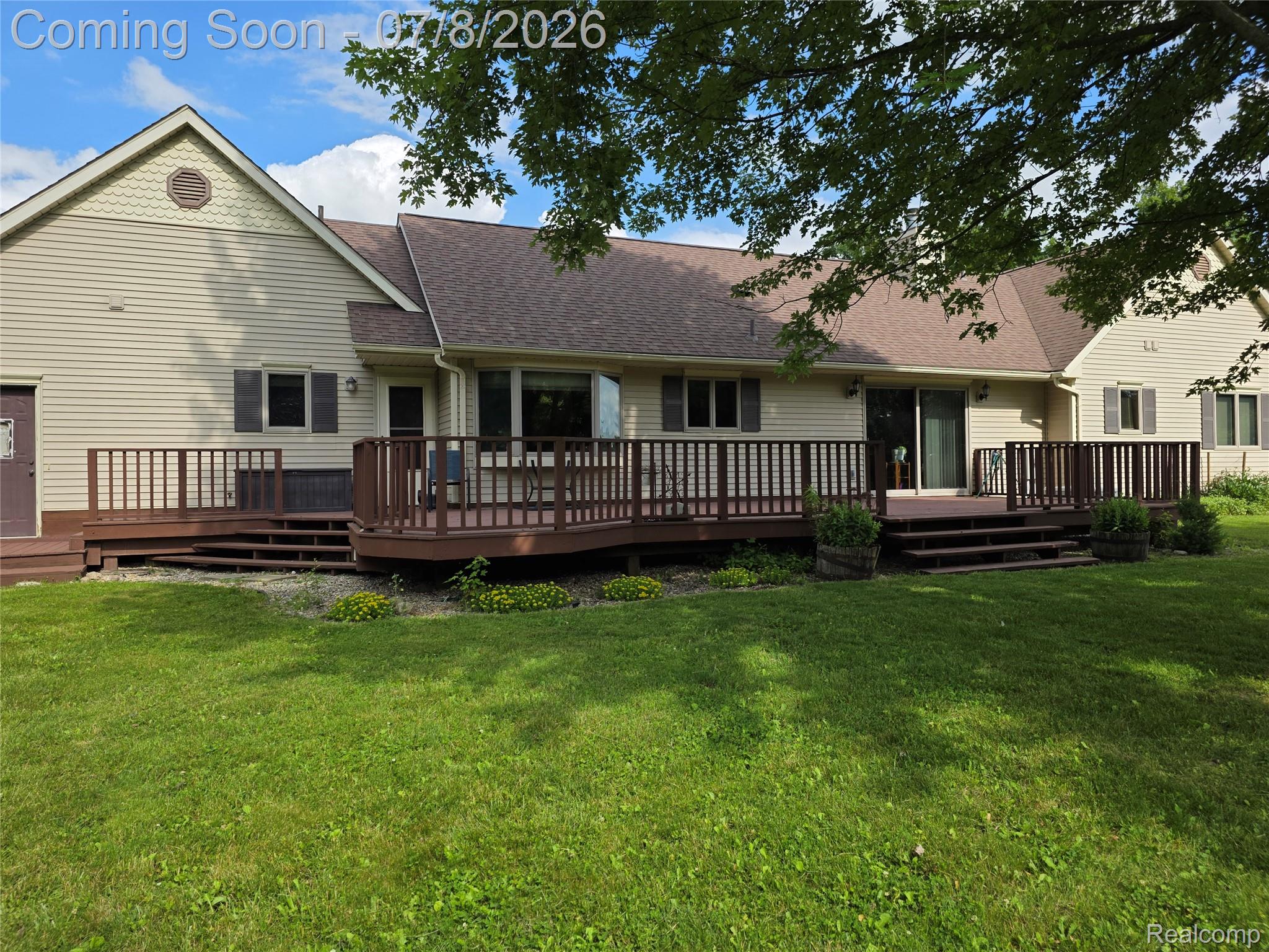 3581 North Burkhart Road Howell, MI 48855 - Photo 6 of 15 Extensive multi-level wood deck and patio doors