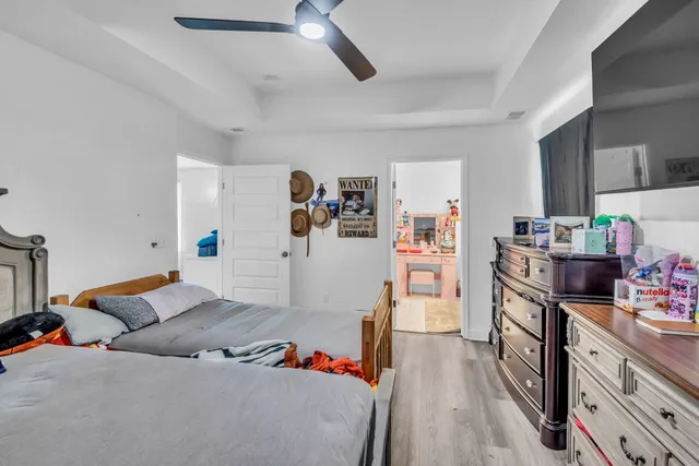 a bedroom with furniture and a wooden floor