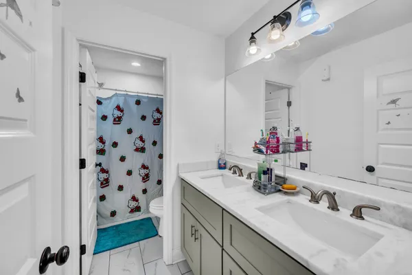 a bathroom with a sink double vanity and a mirror