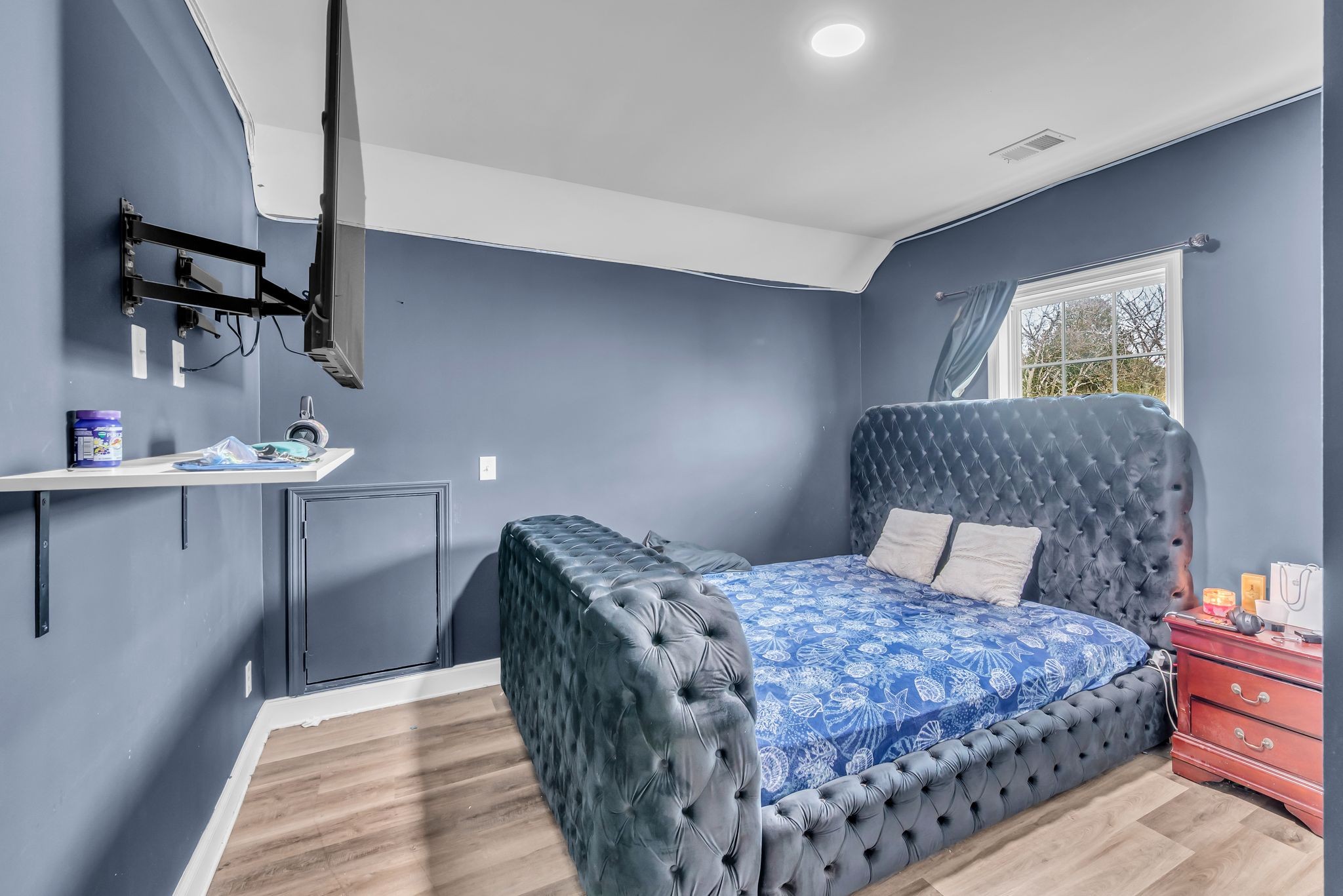 412 Larkin Springs Road Madison, TN 37115 - Photo 25 of 29 a bedroom with a large bed and a chandelier