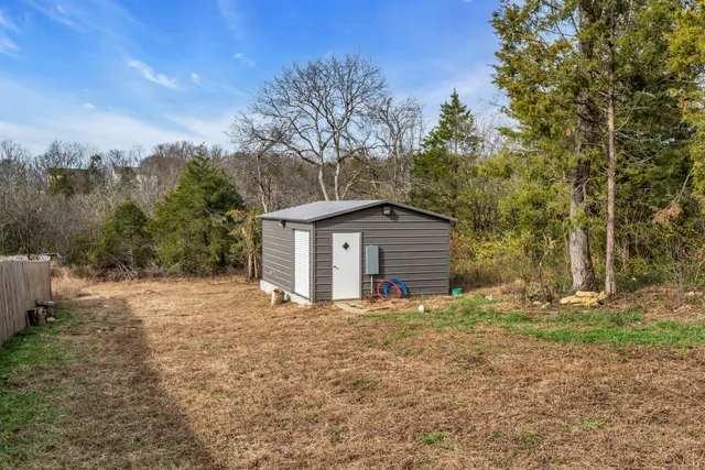 a white house that has a tree in front of it