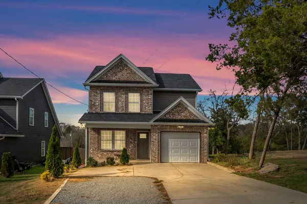 a front view of a house with a garden