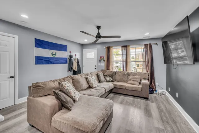a living room with furniture and a large window