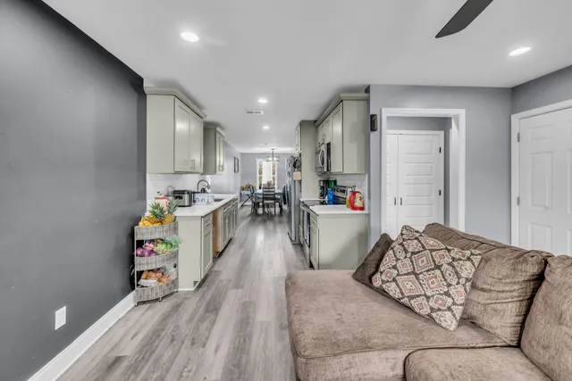 a living room with furniture and a wooden floor