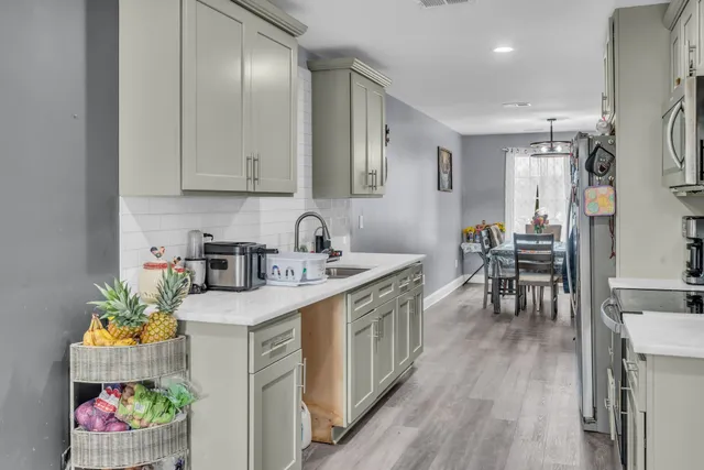 a kitchen with a sink stove and cabinets
