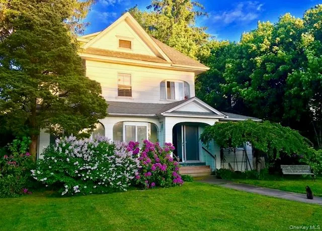 a front view of a house with a garden