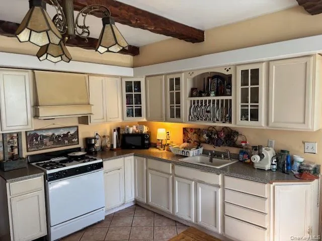 a kitchen with stainless steel appliances a stove a sink and cabinets