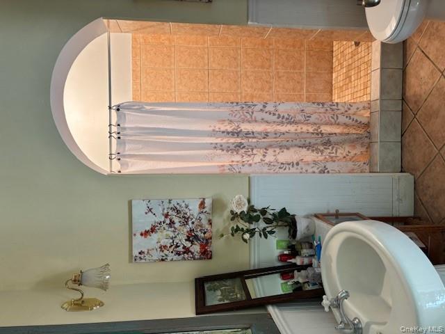 761 East Main Street Riverhead, NY 11901 - Photo 10 of 17 a bathroom with a sink and a mirror