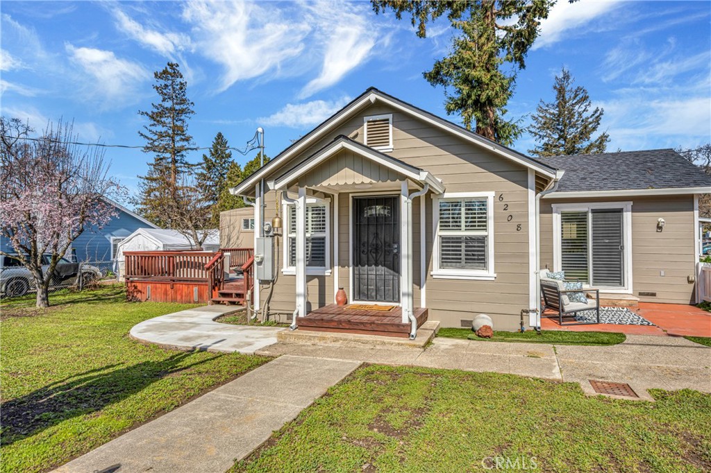 a front view of a house with a yard table and chairs
