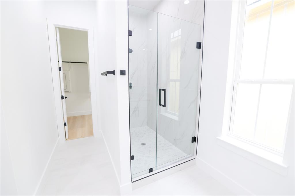 302 East 7th Street, Unit B Dallas, TX 75203 - Photo 14 of 15 a bathroom with a glass shower door