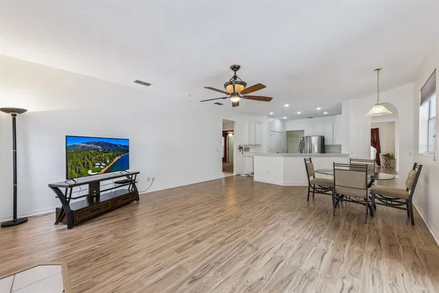 a living room with furniture and a wooden floor