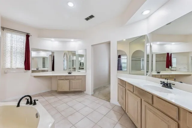 a bathroom with a double vanity sink mirror and double