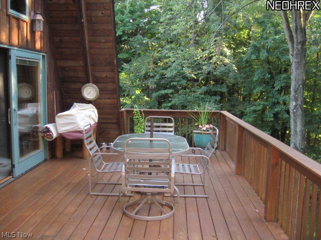 5838 Fairland Road Clinton, OH 44216 - Photo 11 of 25 DECK OFF GREAT ROOM AREA - DUAL PELLA DOORS - EXTENDS ACROSS THE BACK OF THE HOUSE. OVERLOOKS WOODED VIEW - CONCRETE PATIO AND DUAL SLIDING DOORS FROM REC RM/OFFICE UNDERNEATH