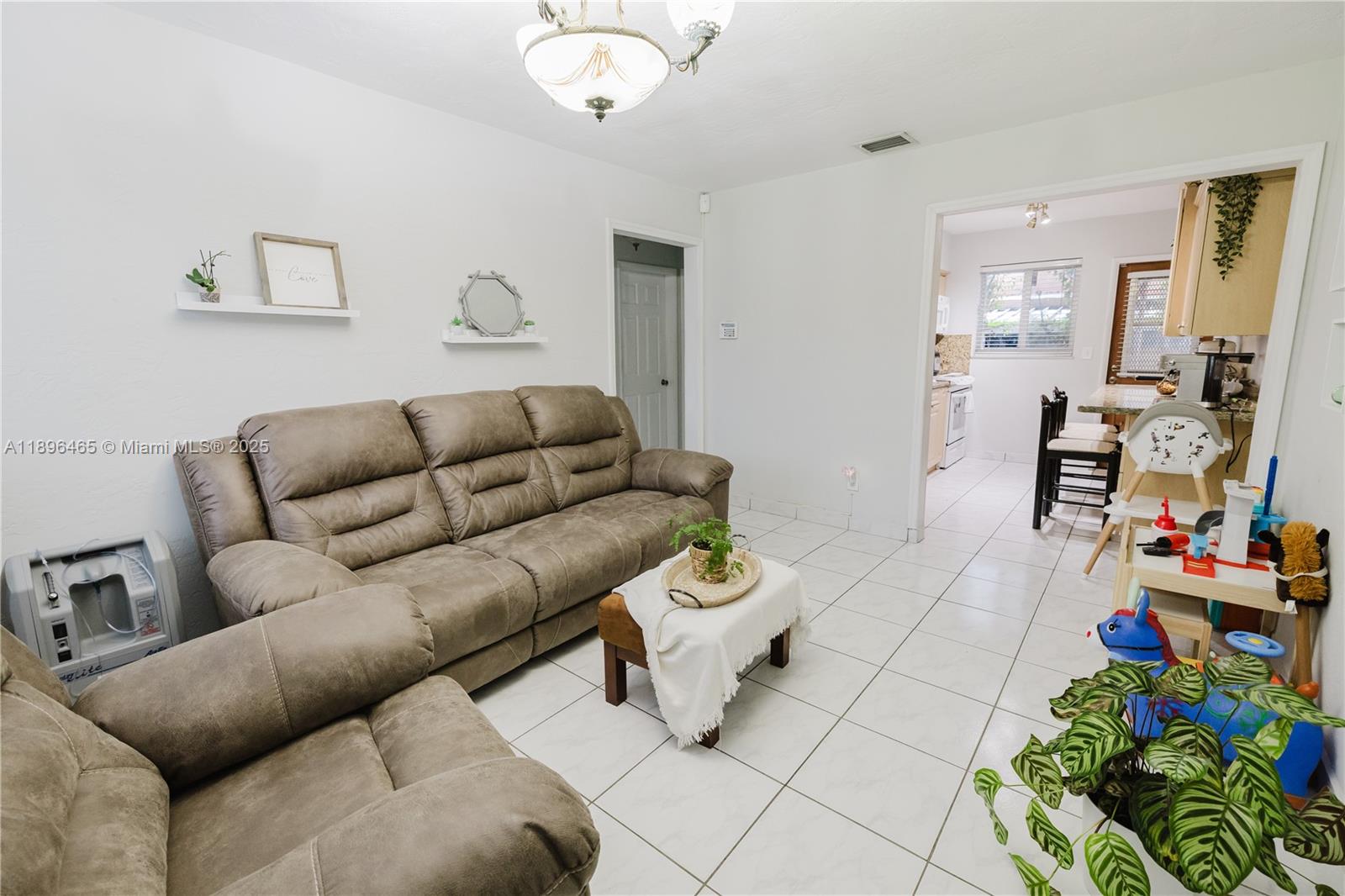 2211 Southwest 75th Avenue, Unit 1 Miami, FL 33155 - Photo 2 of 9 a living room with furniture and a dining table