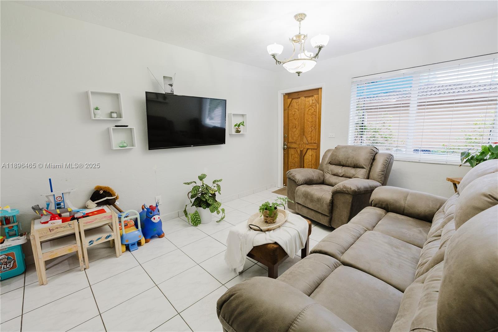 2211 Southwest 75th Avenue, Unit 1 Miami, FL 33155 - Photo 3 of 9 a living room with furniture and a flat screen tv