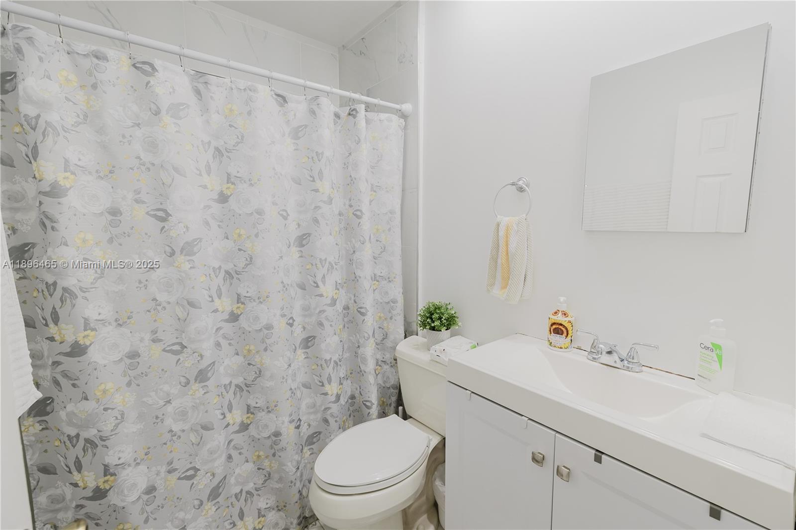 2211 Southwest 75th Avenue, Unit 1 Miami, FL 33155 - Photo 5 of 9 a bathroom with a sink a toilet and a mirror