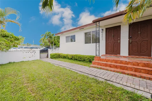 a front view of a house with a garden