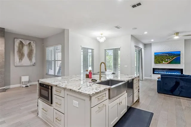 a kitchen with sink stove and refrigerator