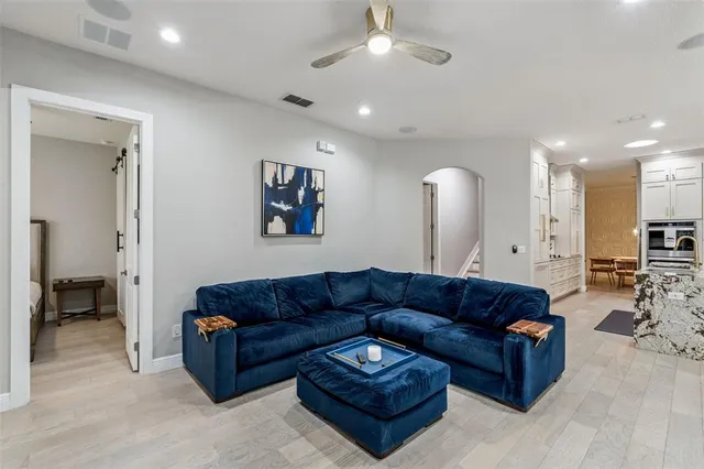 a view of a living room kitchen and a wooden floor