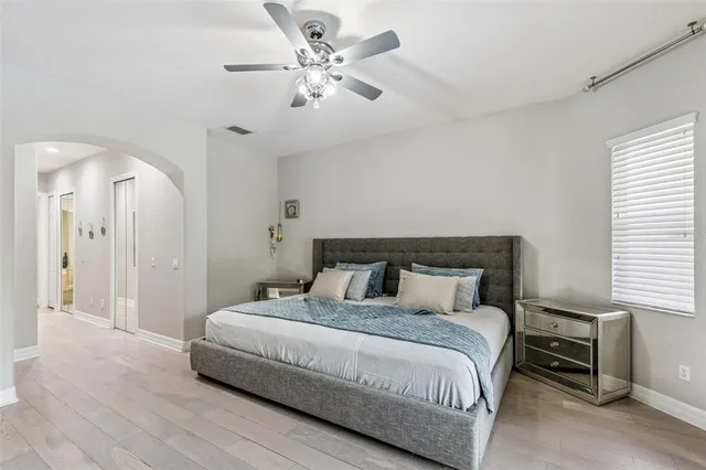 a bedroom with a bed and a chandelier