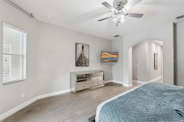 a bedroom with furniture and a chandelier