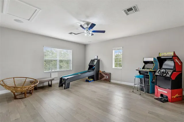 a living room with furniture gym equipment and a window
