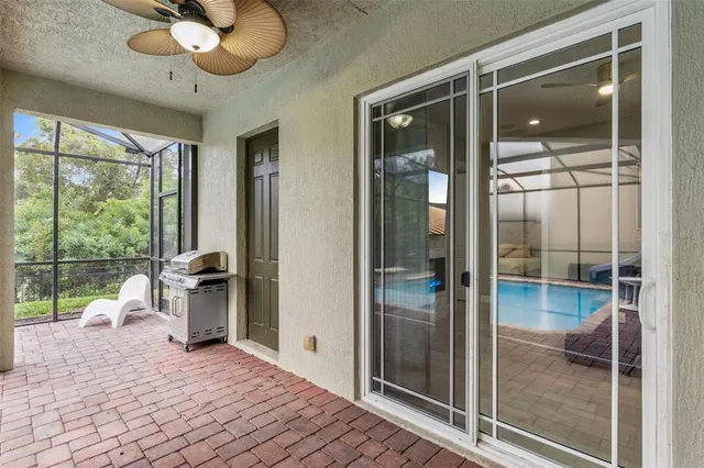 a bathroom with a glass shower door and a window
