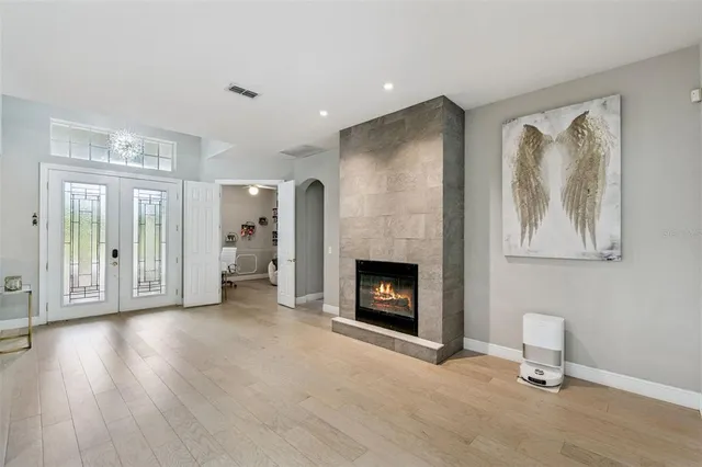 a view of an empty room with a fireplace and a window