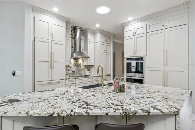 a kitchen with kitchen island granite countertop a stove and refrigerator