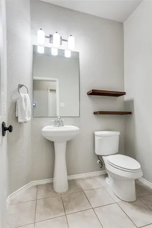 a bathroom with a sink toilet and mirror