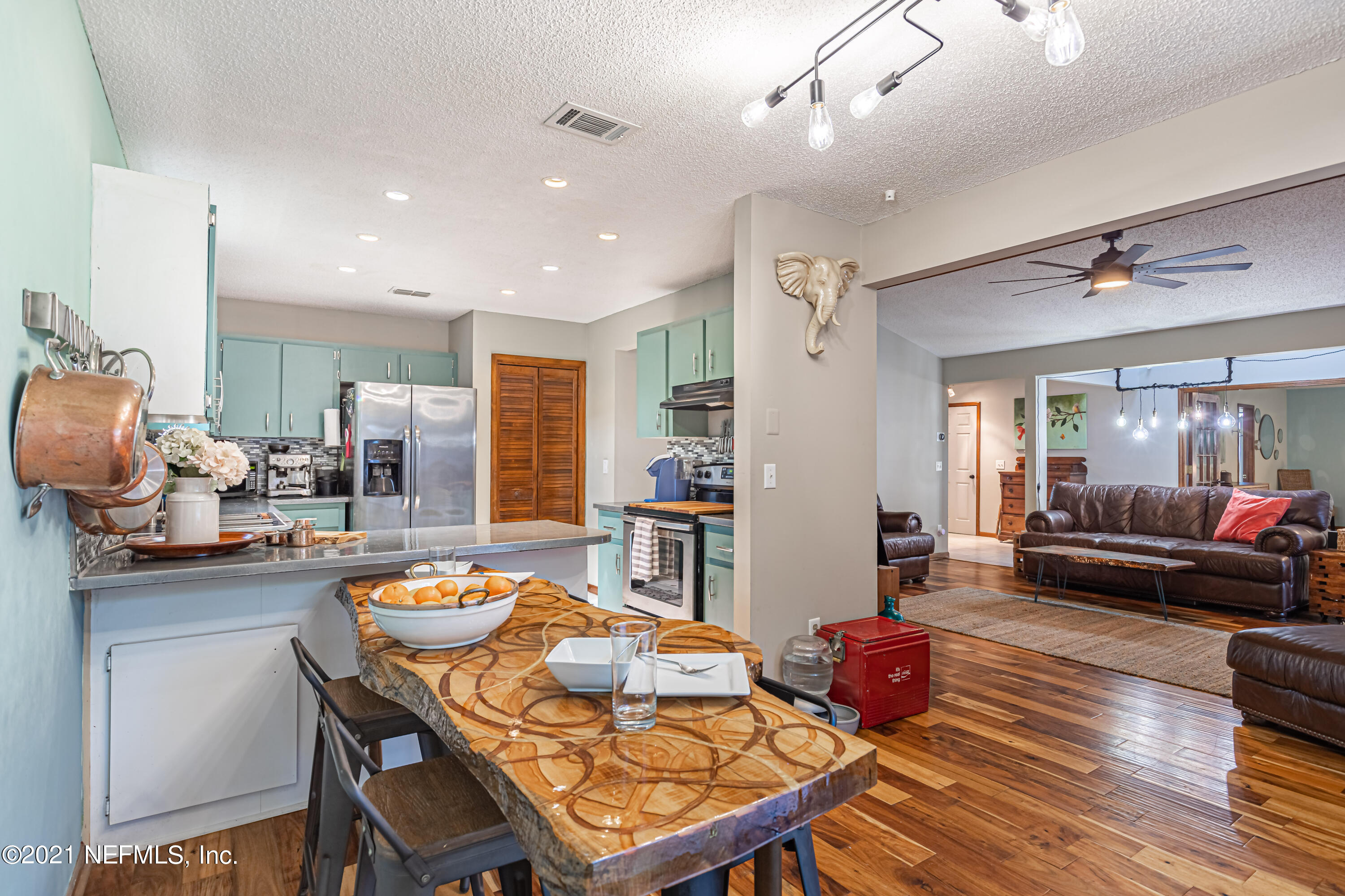 12825 Ridgemore Lane Jacksonville, FL 32258 - Photo 17 of 37 a living room with stainless steel appliances furniture a dining table and chairs