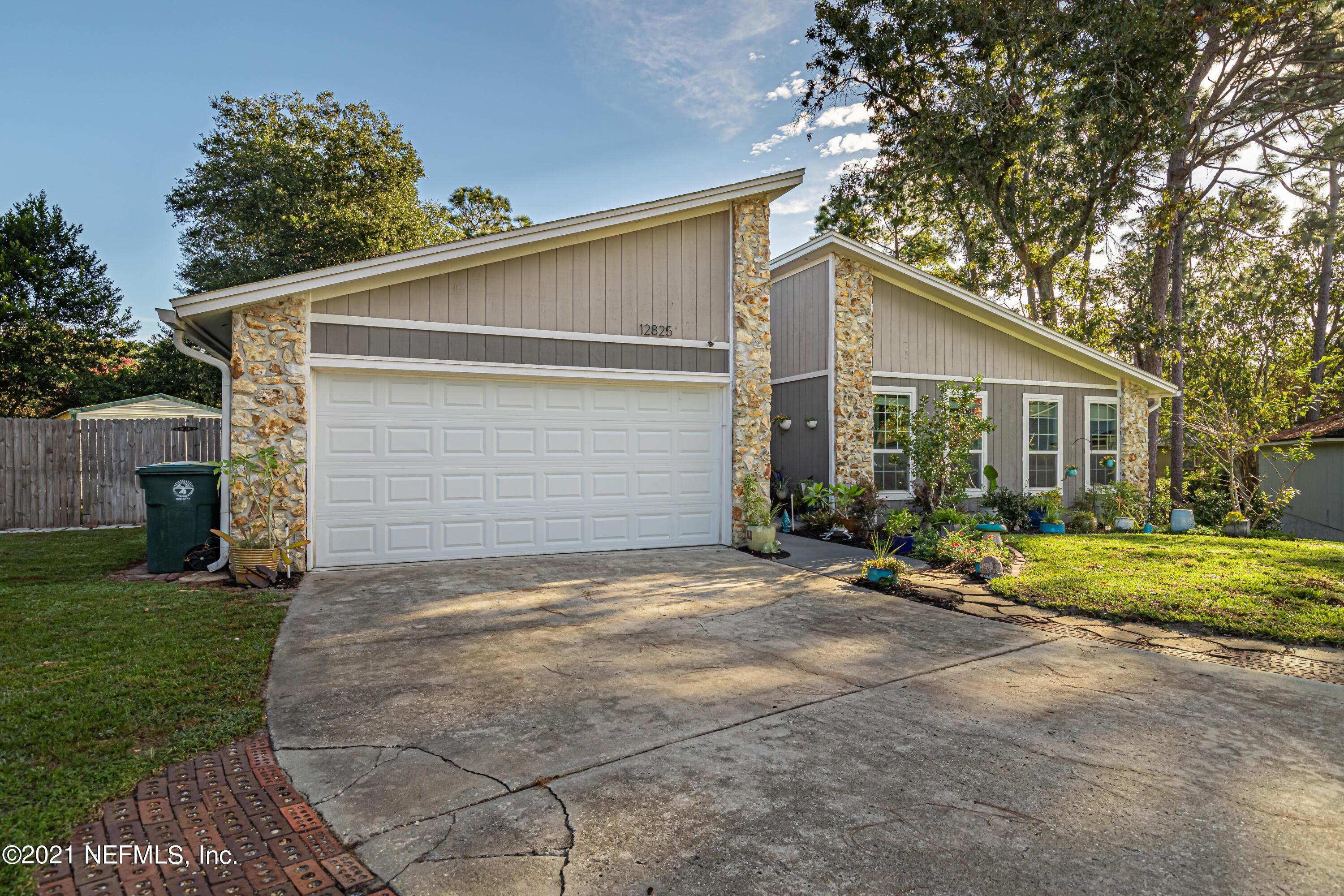 12825 Ridgemore Lane Jacksonville, FL 32258 - Photo 2 of 37 a view of backyard of house with outdoor seating and green space