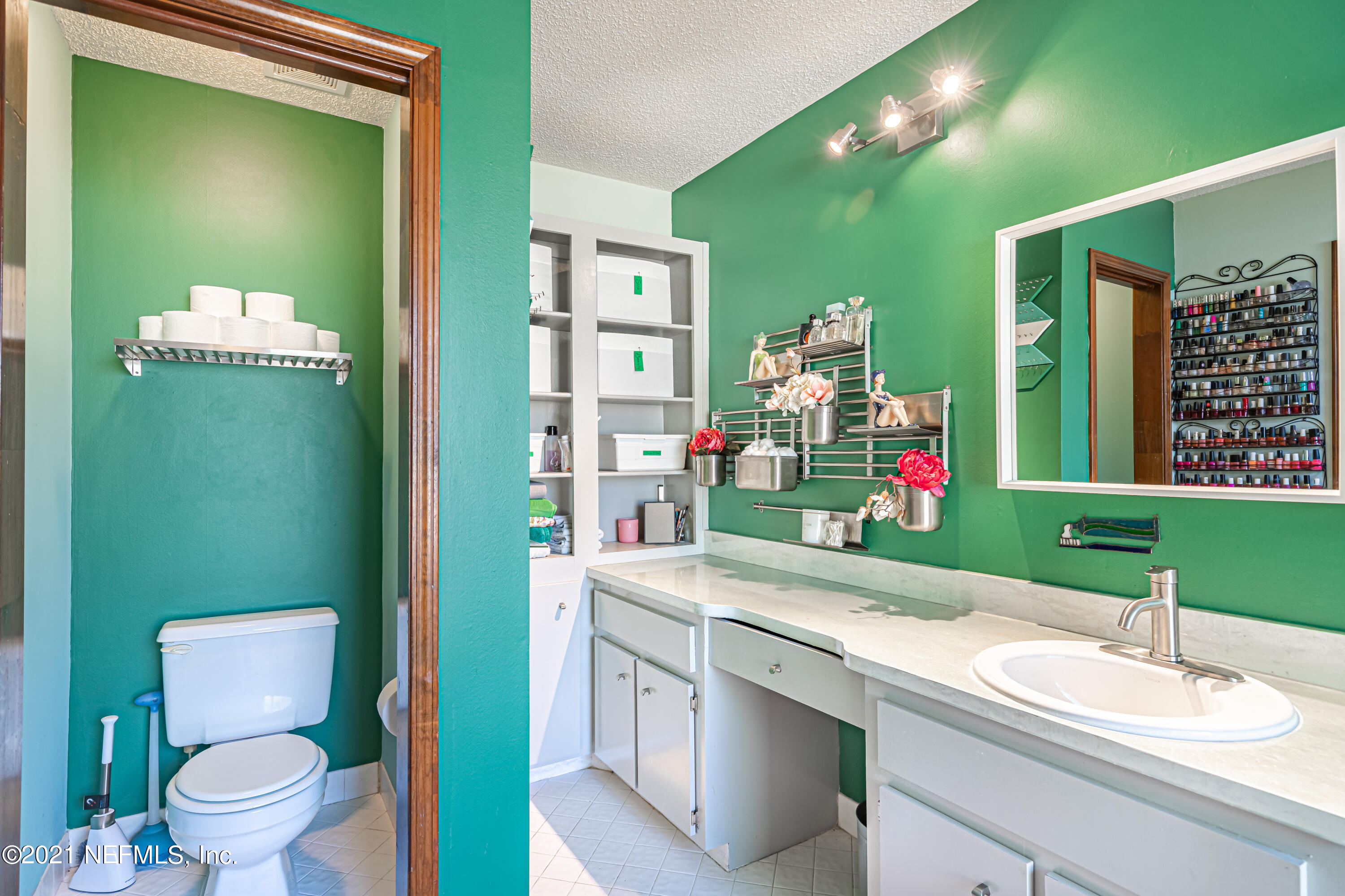 12825 Ridgemore Lane Jacksonville, FL 32258 - Photo 22 of 37 a bathroom with a sink mirror vanity and toilet