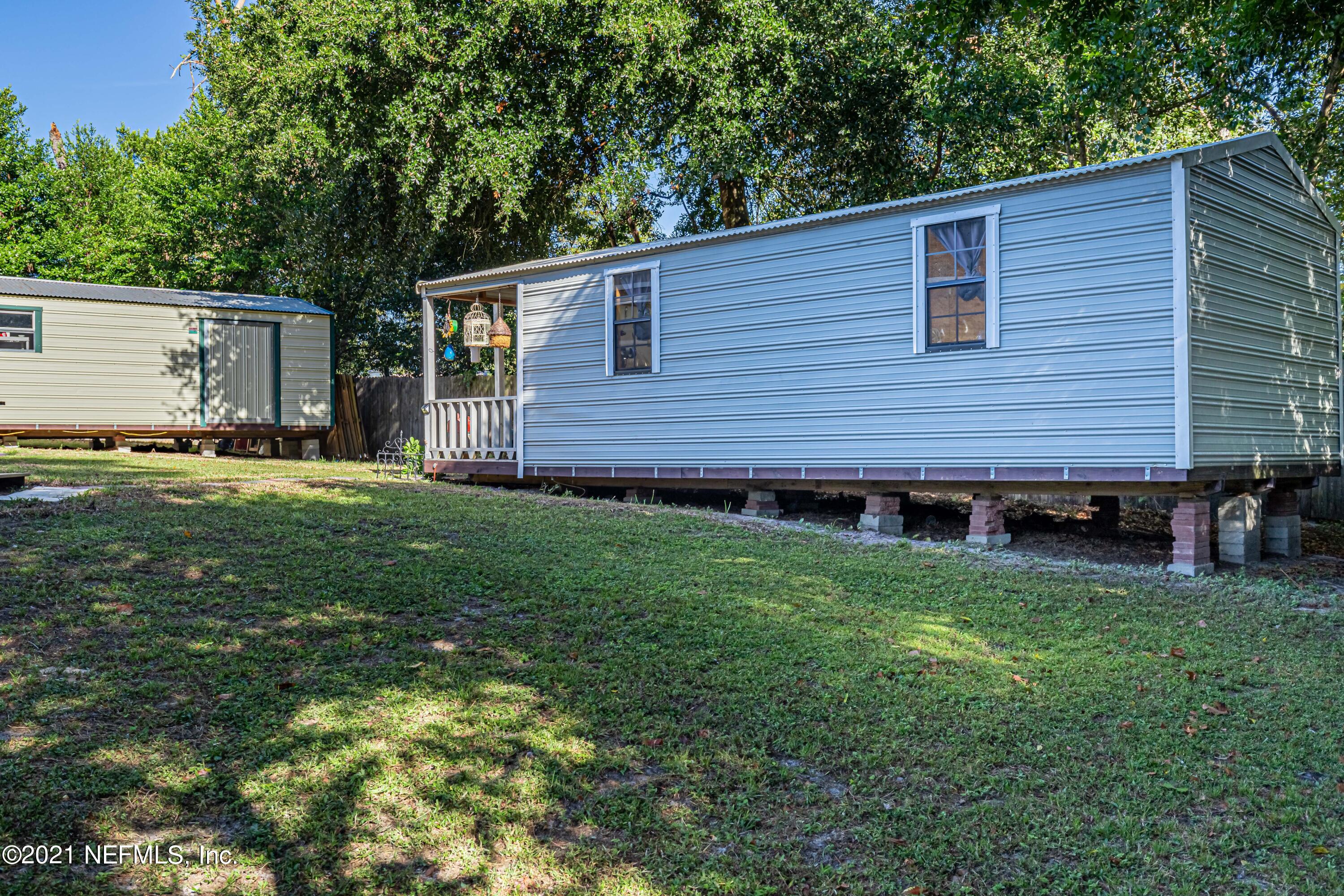 12825 Ridgemore Lane Jacksonville, FL 32258 - Photo 29 of 37 a view of a backyard with potted plants and large tree