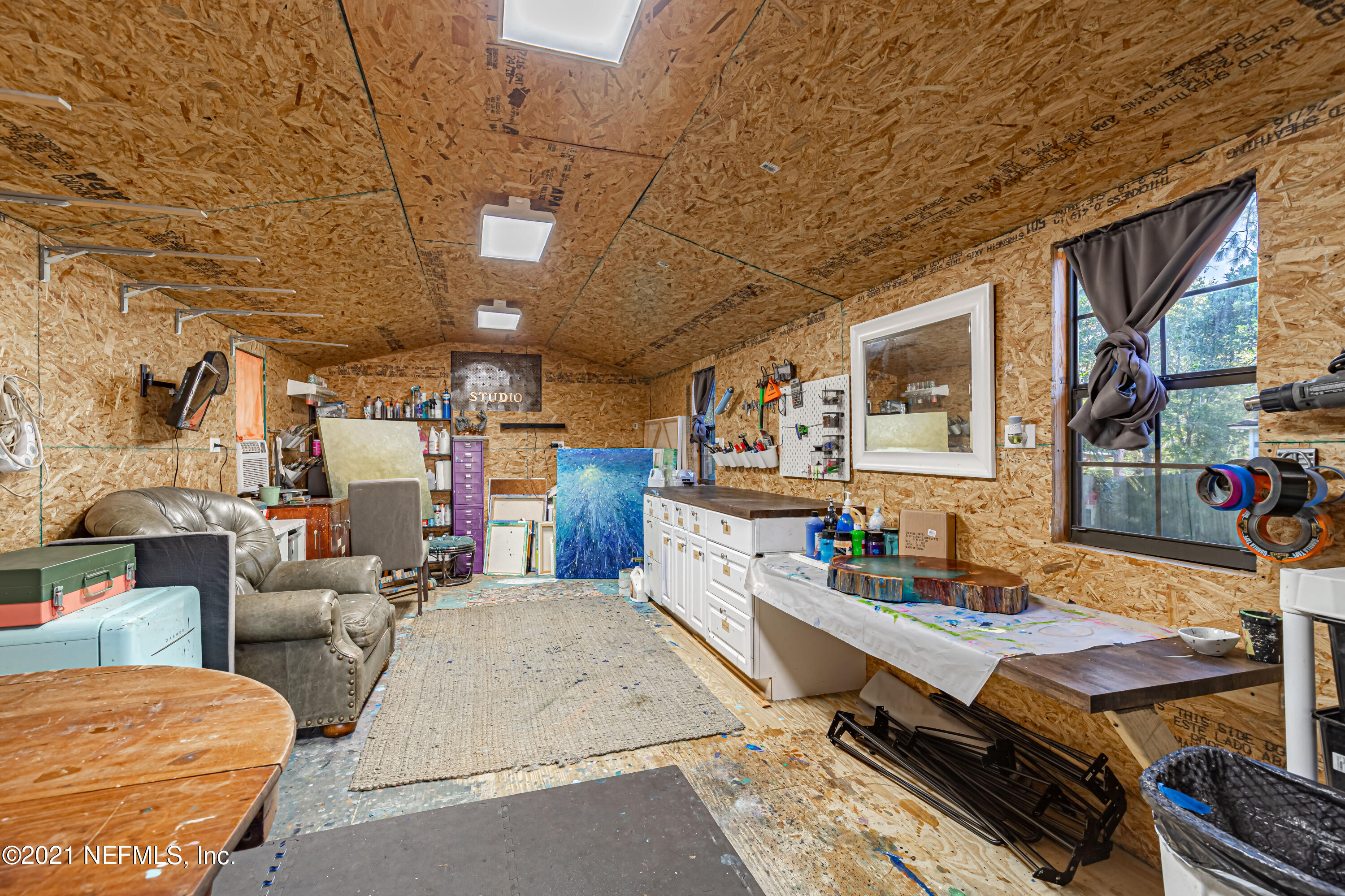 12825 Ridgemore Lane Jacksonville, FL 32258 - Photo 31 of 37 a living room with furniture a flat screen tv and a table