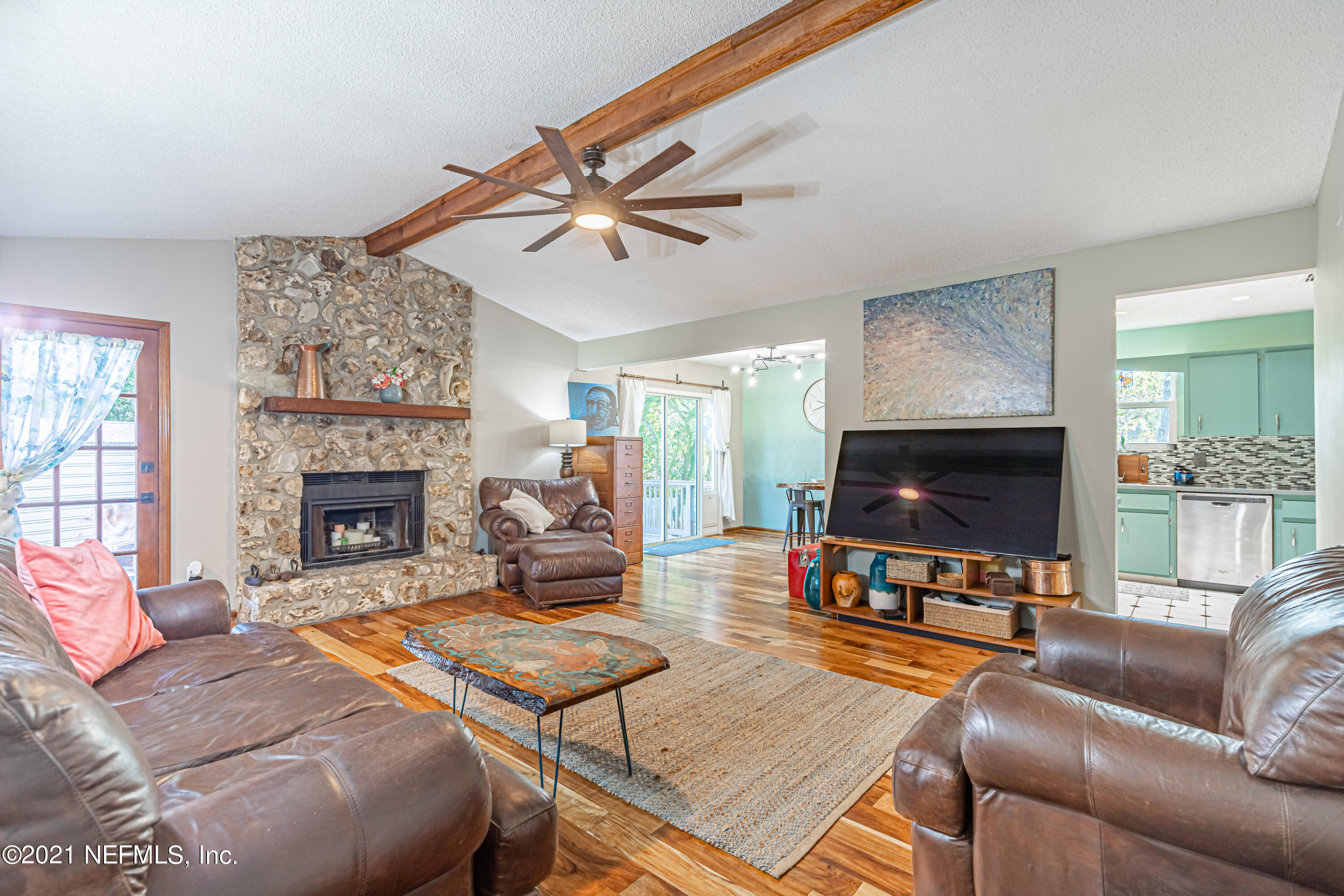 12825 Ridgemore Lane Jacksonville, FL 32258 - Photo 9 of 37 a living room with furniture a flat screen tv and a fireplace