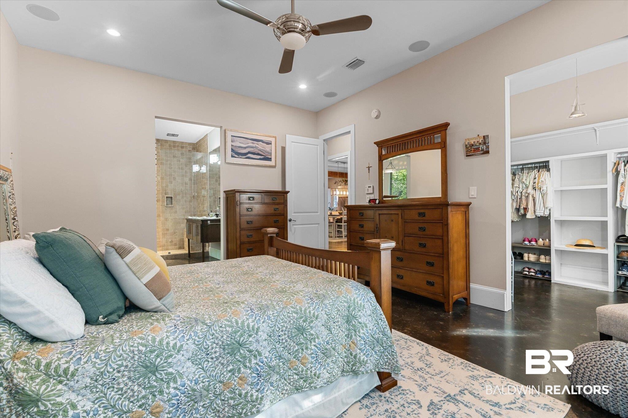 3400 Rue Royal Mobile, AL 36693 - Photo 14 of 33 Bedroom with finished concrete flooring, a walk in closet, recessed lighting, ceiling fan, and ensuite bathroom