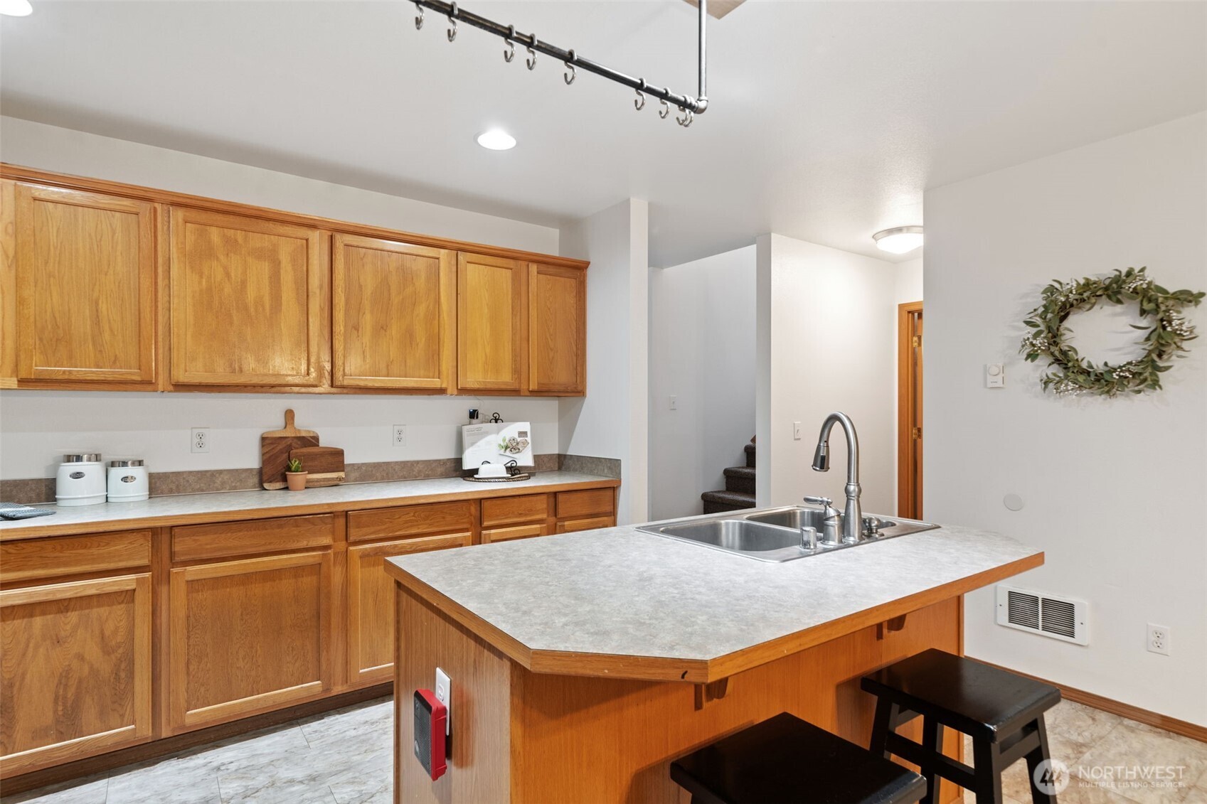 514 Southwest Hipkins Court Port Orchard, WA 98367 - Photo 18 of 39 a kitchen with a sink cabinets and wooden floor