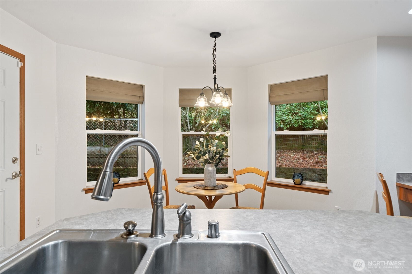 514 Southwest Hipkins Court Port Orchard, WA 98367 - Photo 20 of 39 a kitchen with a faucet a chandelier and living area view