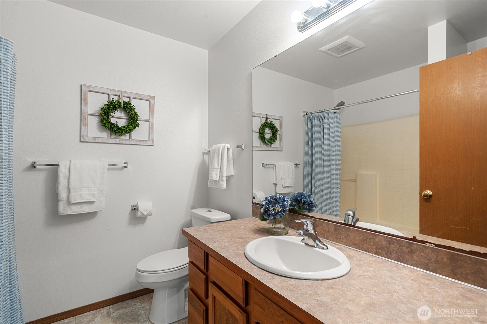 514 Southwest Hipkins Court Port Orchard, WA 98367 - Photo 31 of 39 a bathroom with a sink and a mirror with toilet