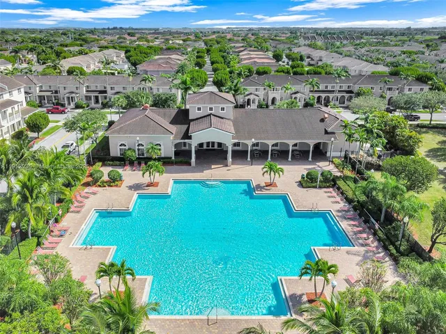 an aerial view of a house with yard swimming pool and outdoor seating