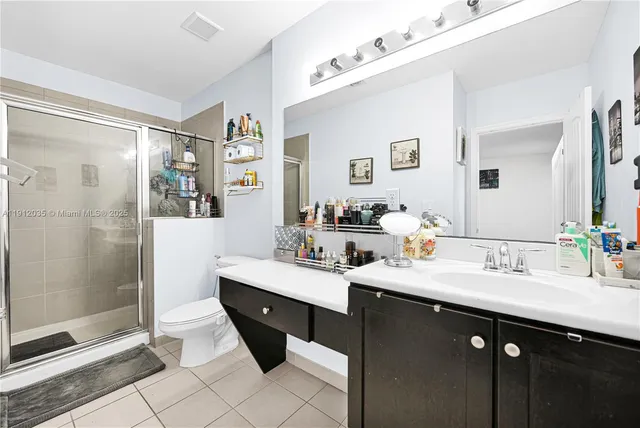 a bathroom with a sink double vanity and shower