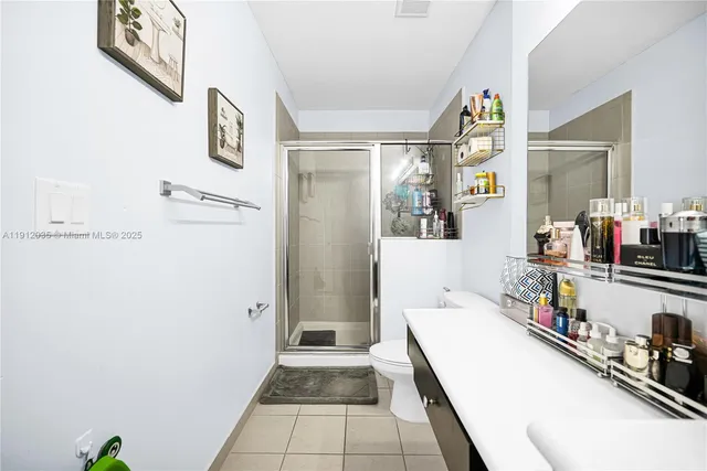 a hallway with a white cabinets and wooden floor