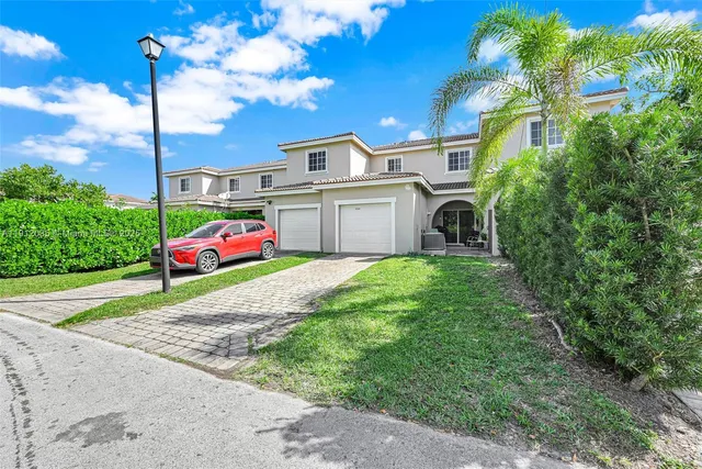 a yellow and red house with a white roof