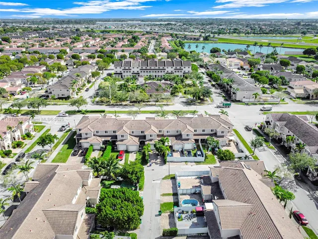 an aerial view of residential houses with outdoor space