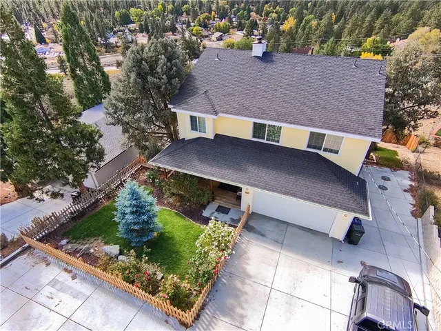 an aerial view of a house with a yard