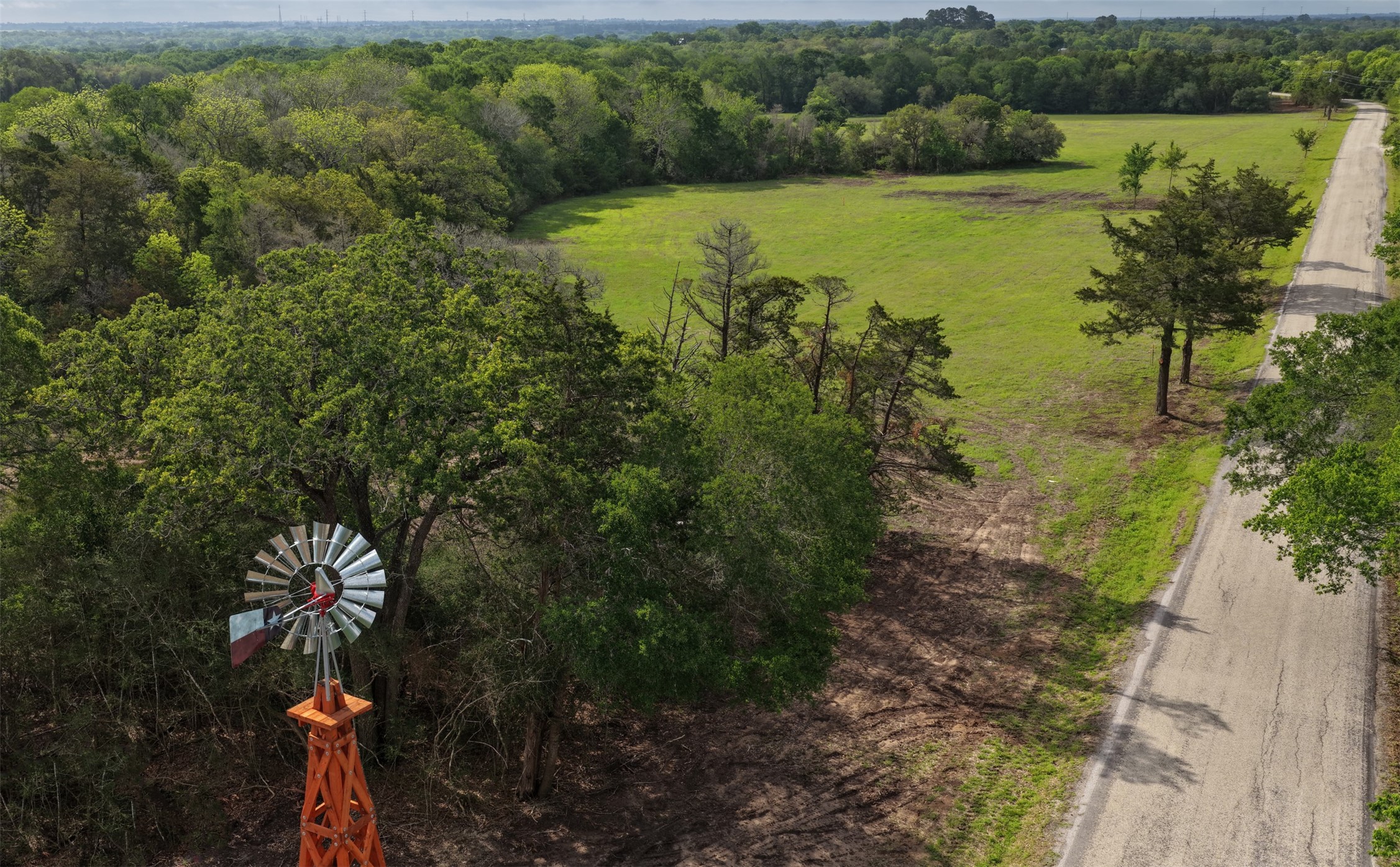 2 Baranowski Road Brenham, TX 77833 - Photo 5 of 7 a view of a lake with a yard and mountain view
