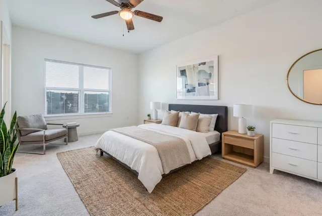 a spacious bedroom with a bed and a couch