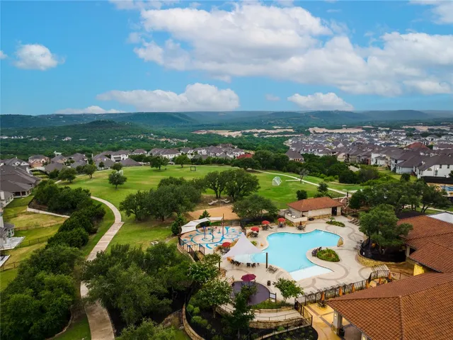 an aerial view of a houses with a city view