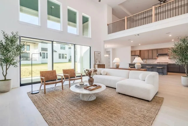 a living room with furniture a flat screen tv and a large window